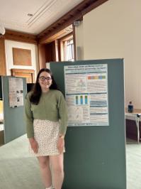 Gwenllian Jenkins presenting a poster of her research at the Coleg Cymraeg Cenedlaethol Conference in June 2025